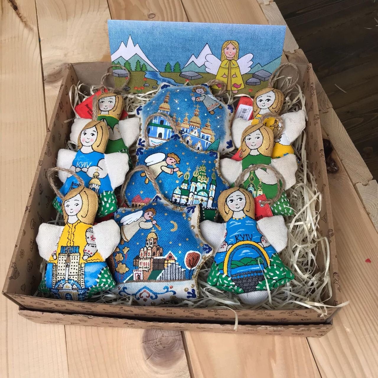 A set Christmas tree decorations depicting various characters and scenes, made of fabric