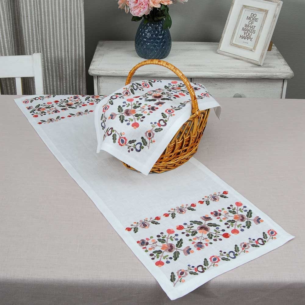 A white linen tabletop with modern embroidered floral patterns