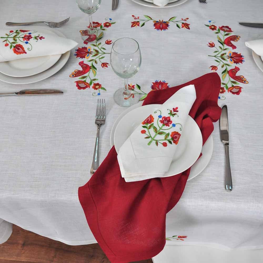 white linen tablecloth with a floral embroidered design