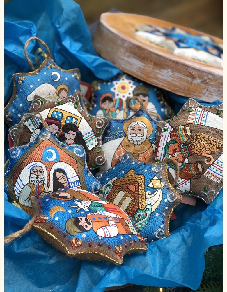 set of Ukrainian Christmas tree decorations featuring the Holy Family with a blue background