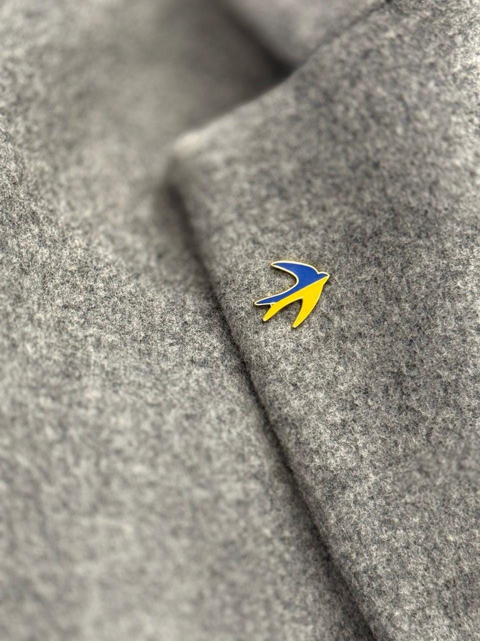 swallow badge with blue and yellow colors