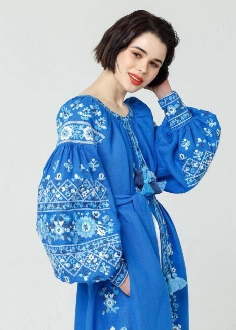 long blue embroidered dress with floral patterns 
