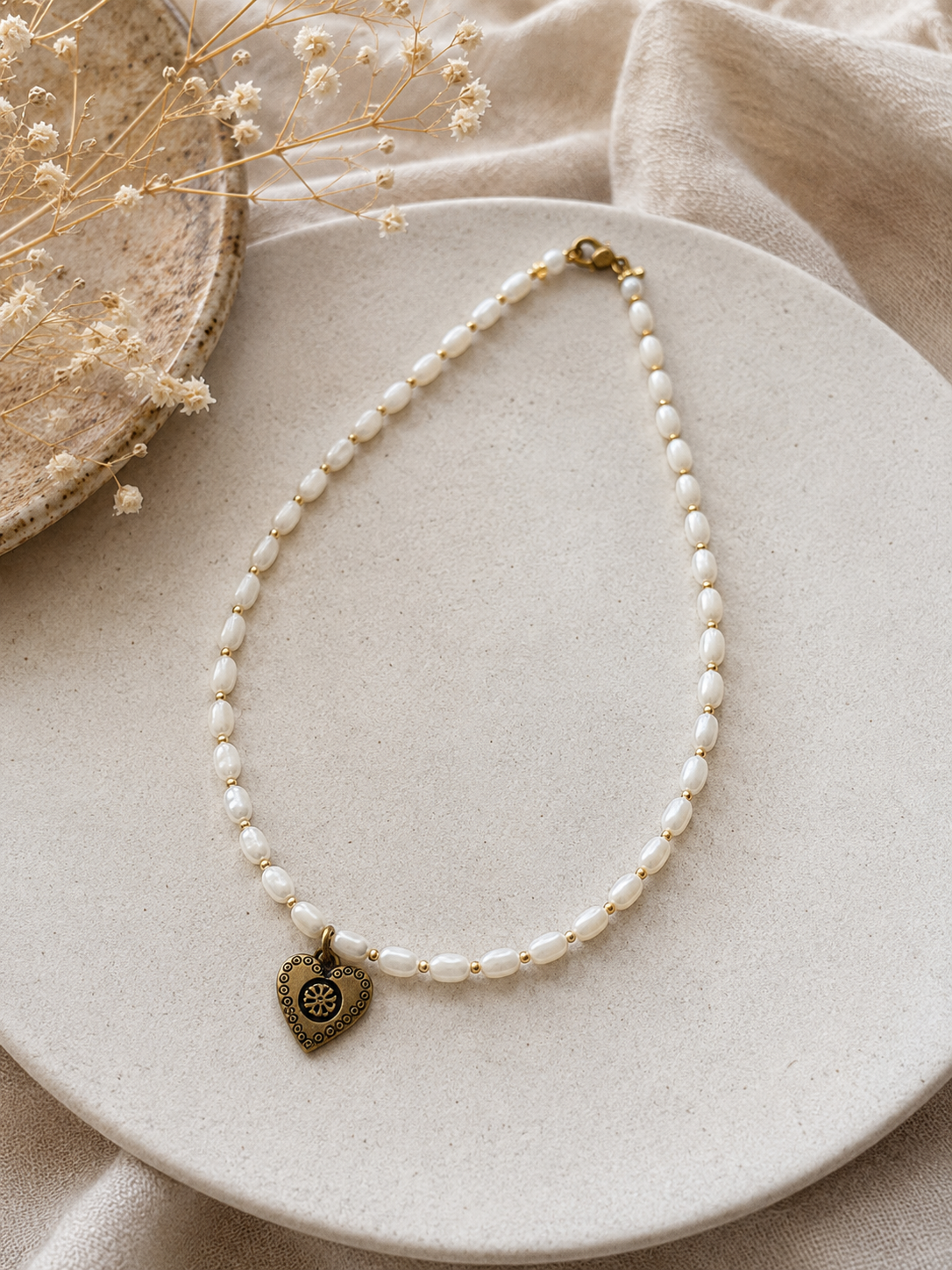 Handmade Romantic Jewelry necklace made of small white pearl-like beads with a gold-toned heart-shaped pendant