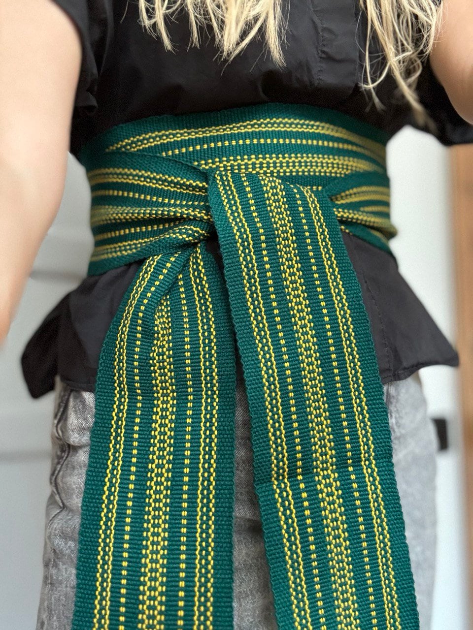 Green woven belt with a geometric pattern 