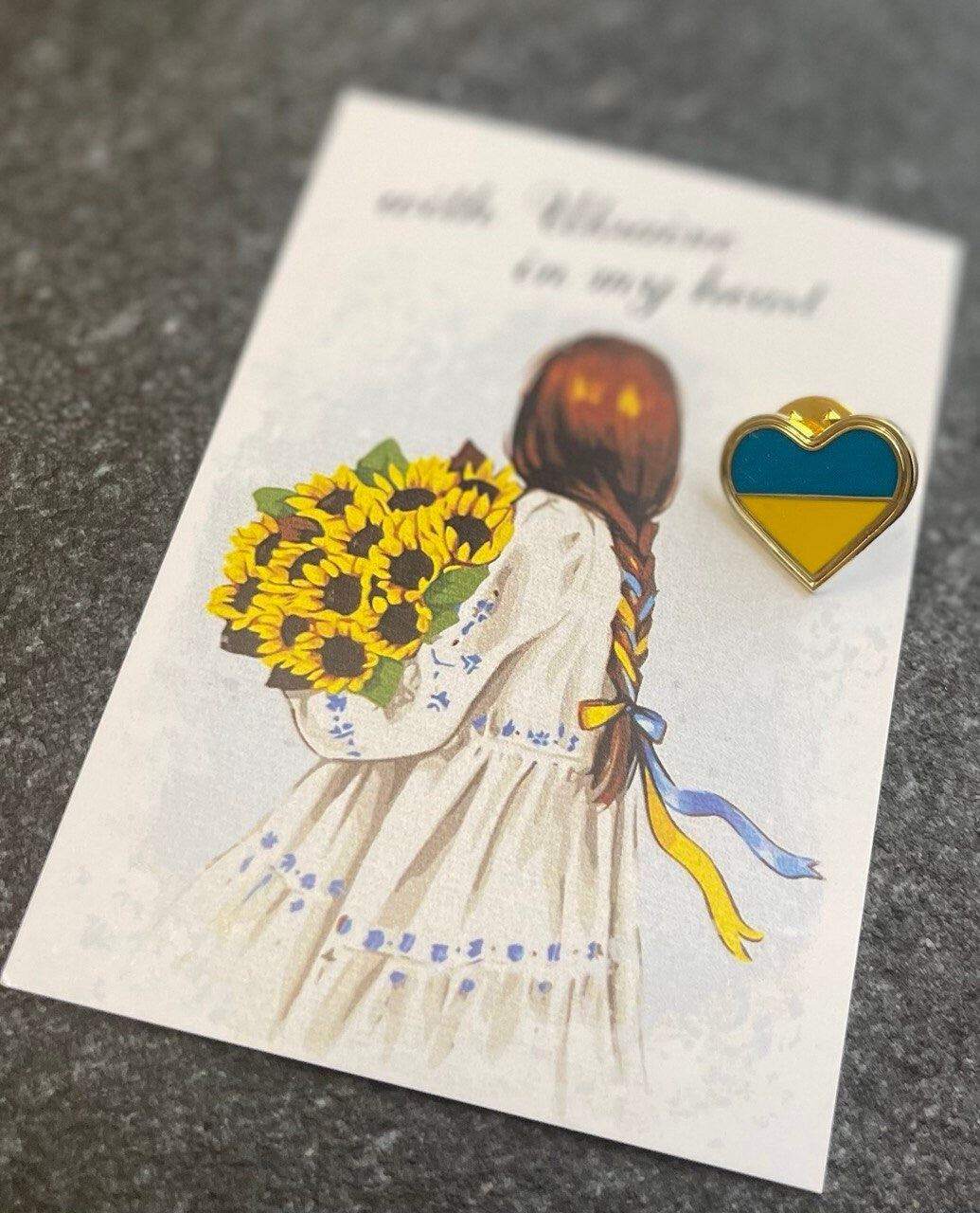 A heart-shaped badge with Ukrainian flag colors 