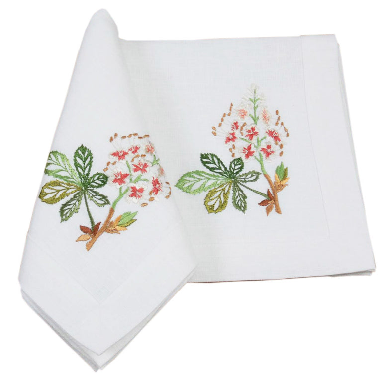 Two white napkins with floral embroidery on a white background