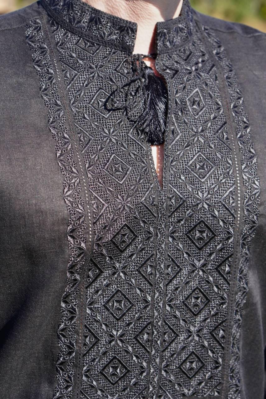 man wearing a black embroidered Ukrainian shirt 