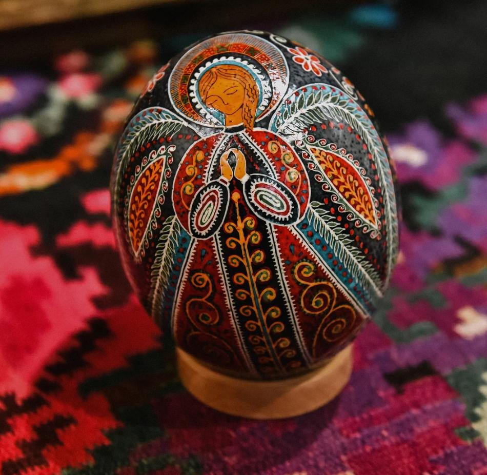 ostrich egg Decorative egg with intricate patterns on a colorful fabric background