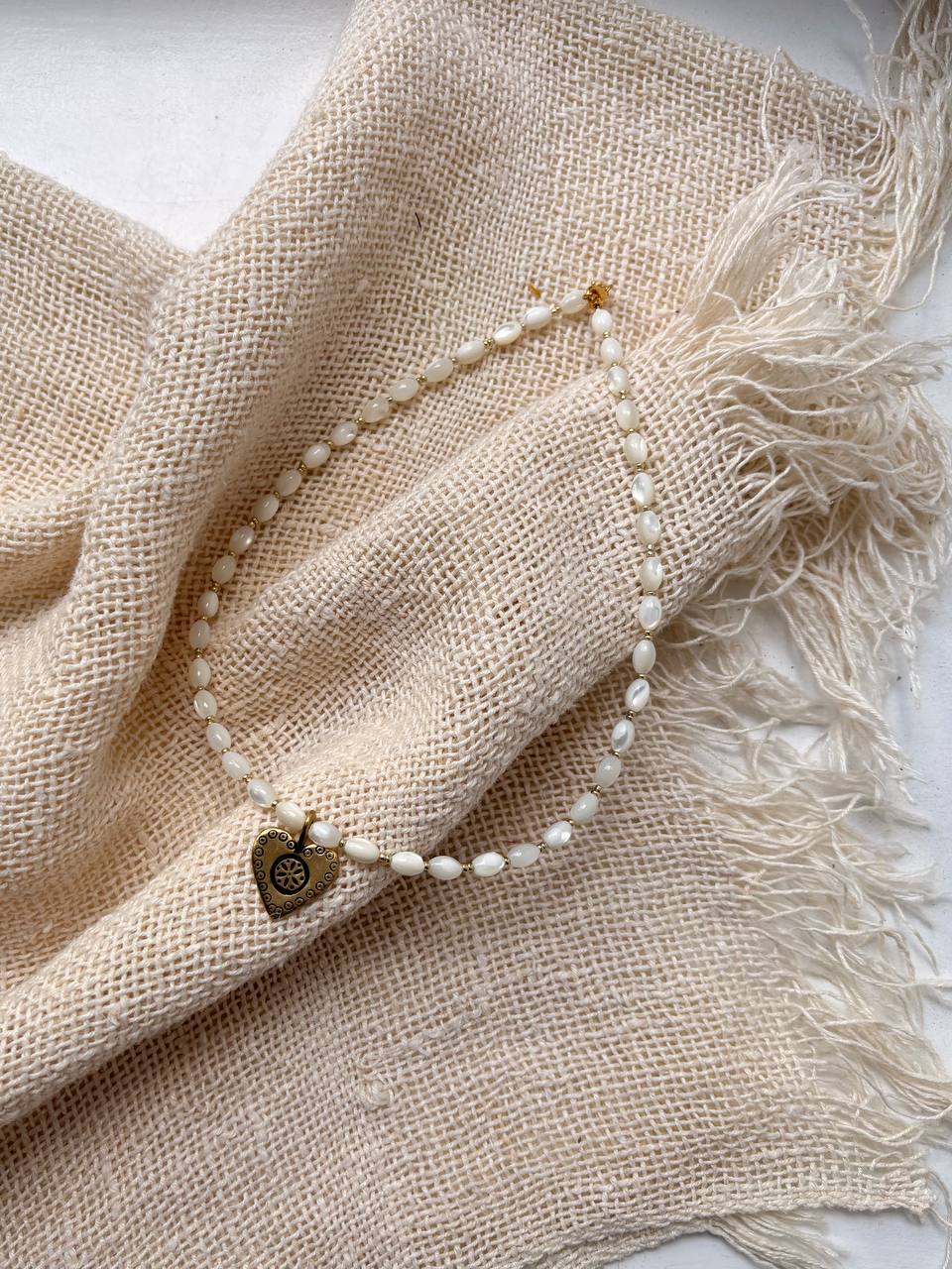 Handmade Romantic Jewelry necklace made of small white pearl-like beads with a gold-toned heart-shaped pendant