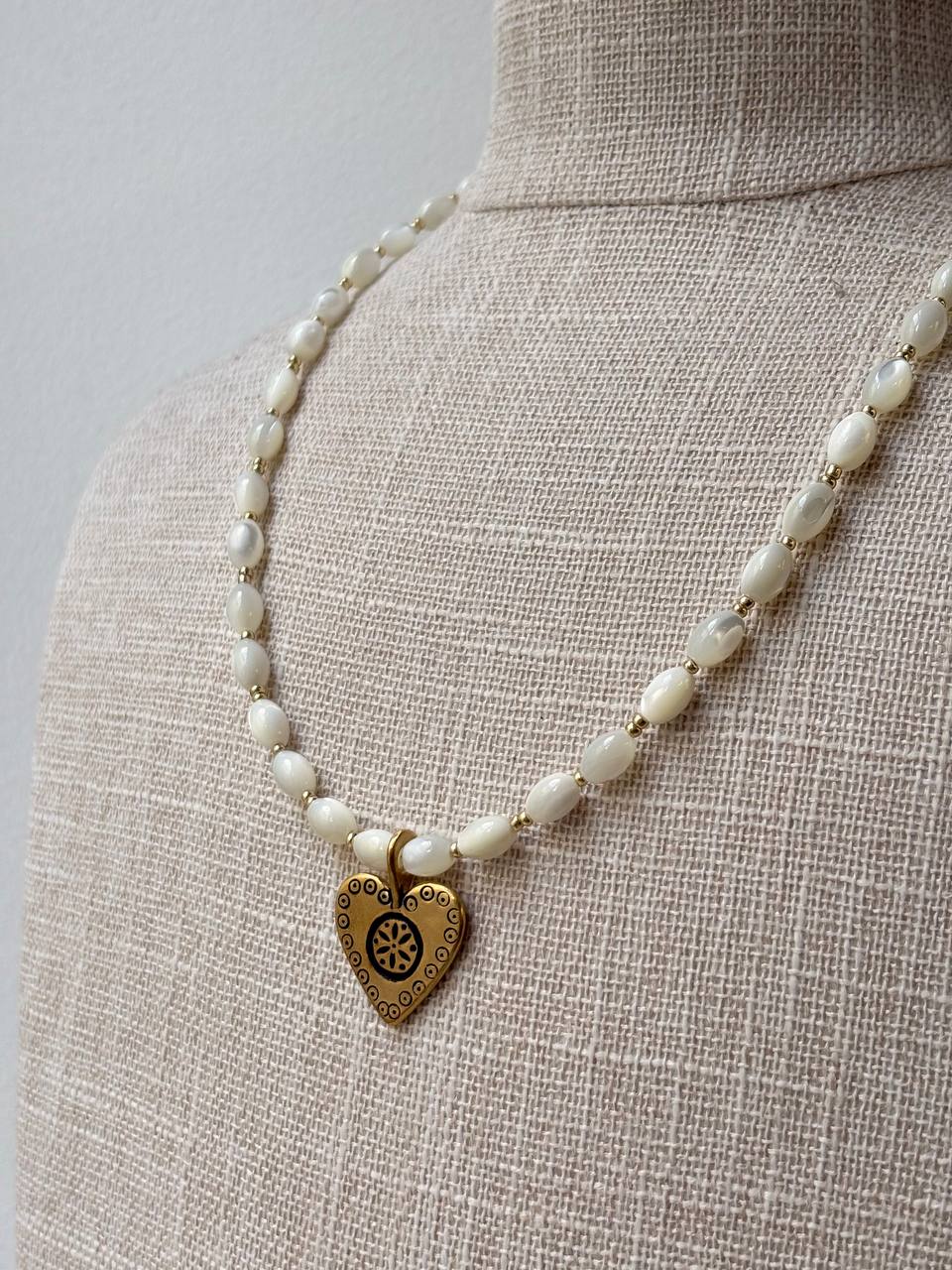 Handmade Romantic Jewelry necklace made of small white pearl-like beads with a gold-toned heart-shaped pendant