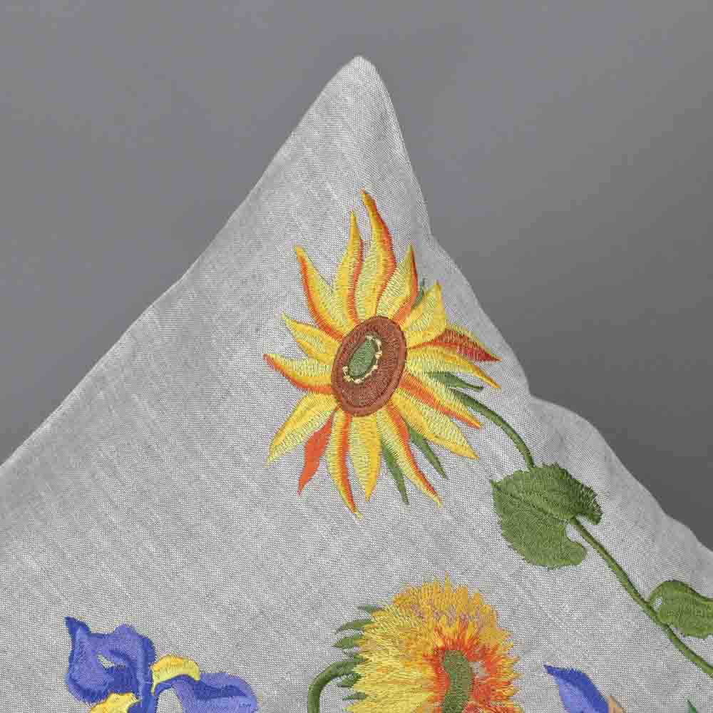 Embroidered sunflower design on a gray fabric background