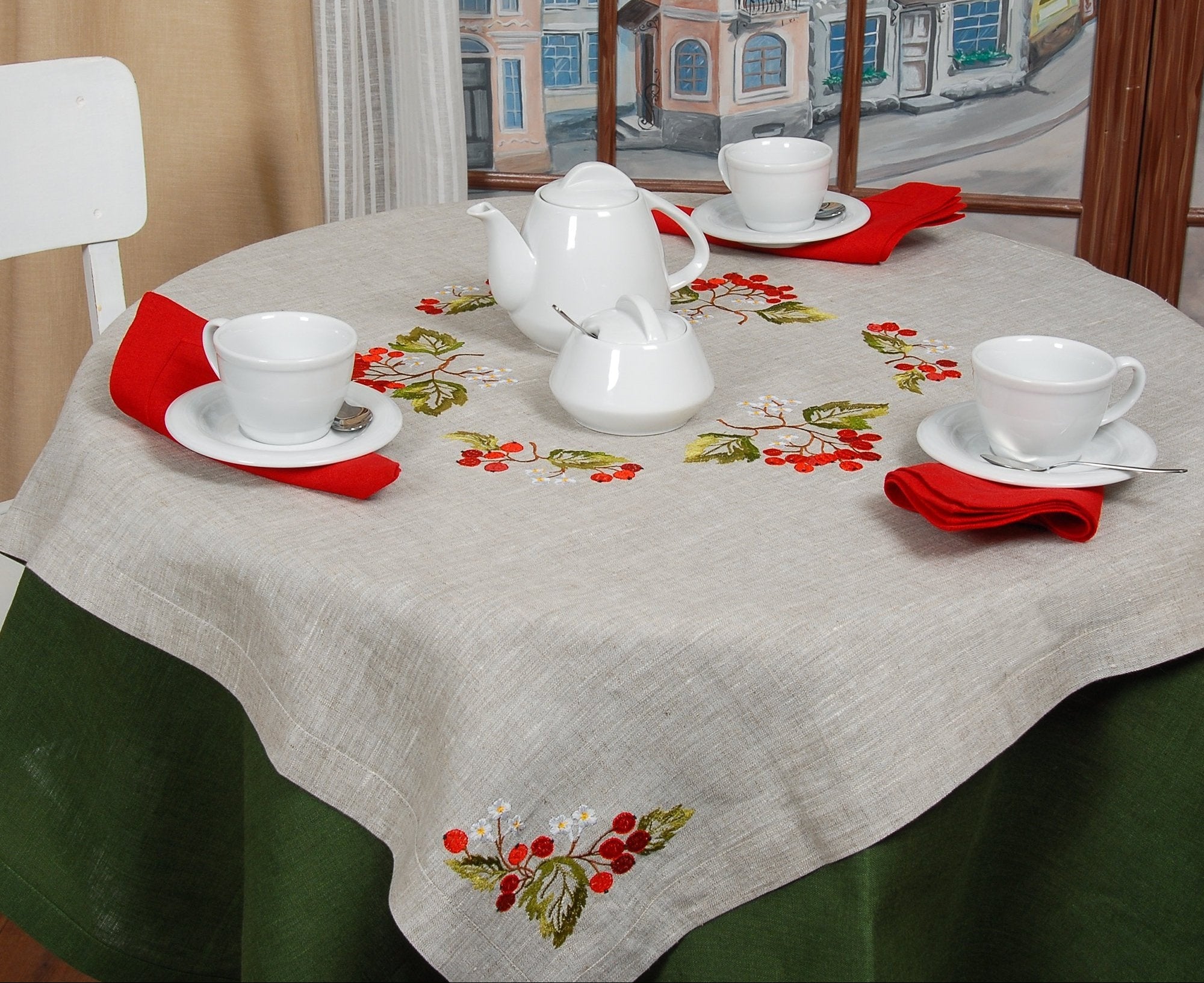 A linen tablecloth with embroidered guelder rose design